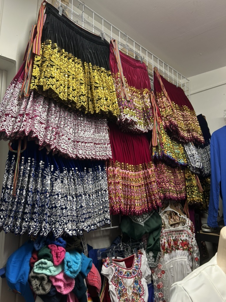 Colorful embroidered traditional skirts and blouses displayed in the shop